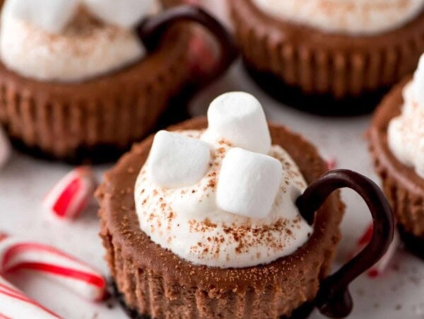 Hot cocoa cheesecake minis topped with marshmallows.