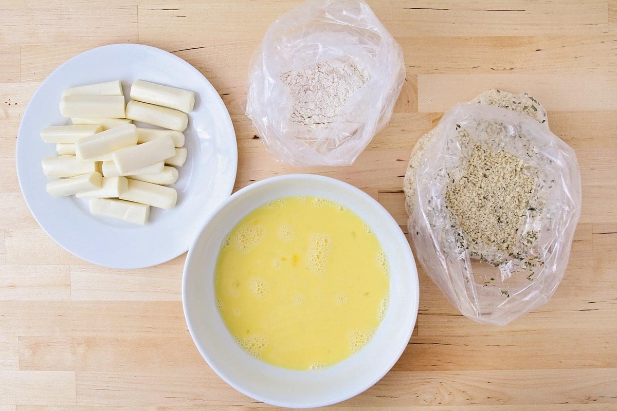 all the ingredients for breading the cheese sticks