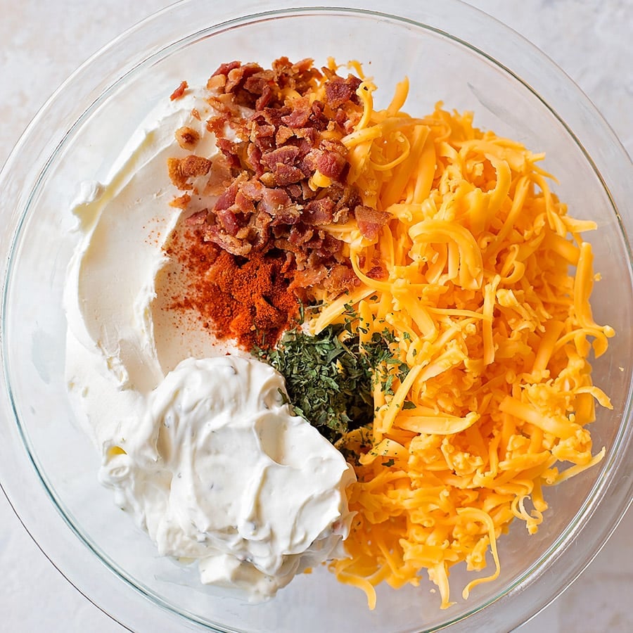 Bacon ranch Cheese ball recipe ingredients in a mixing bowl.