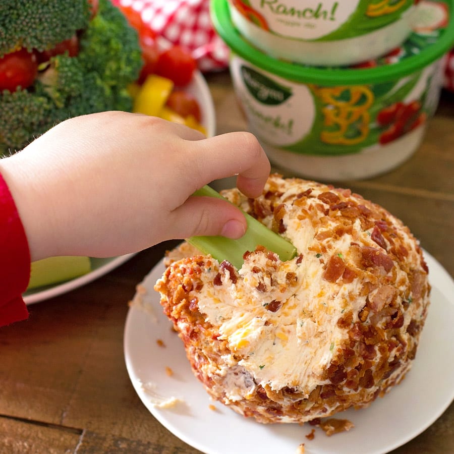 Dipping celery in a bacon ranch cheese ball.