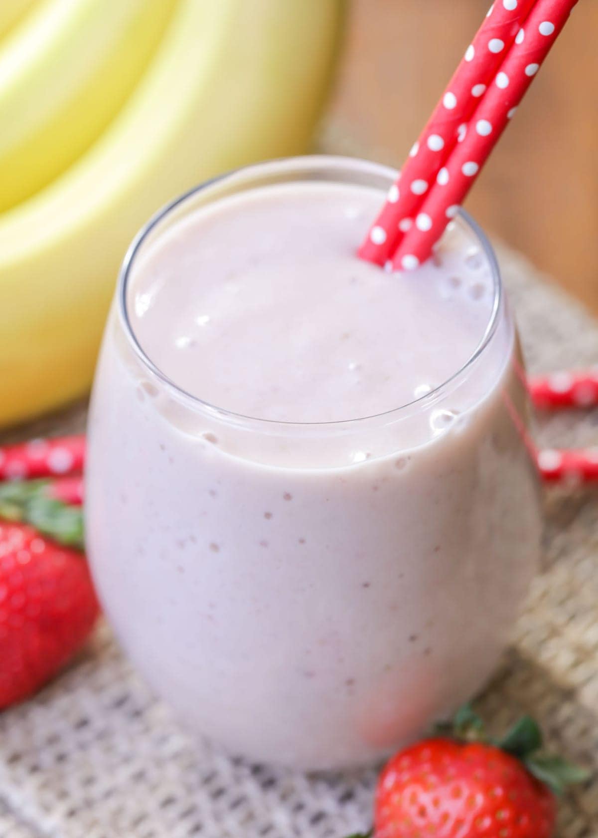 Pineapple banana smoothie - a glass filled with strawberry banana smoothie.