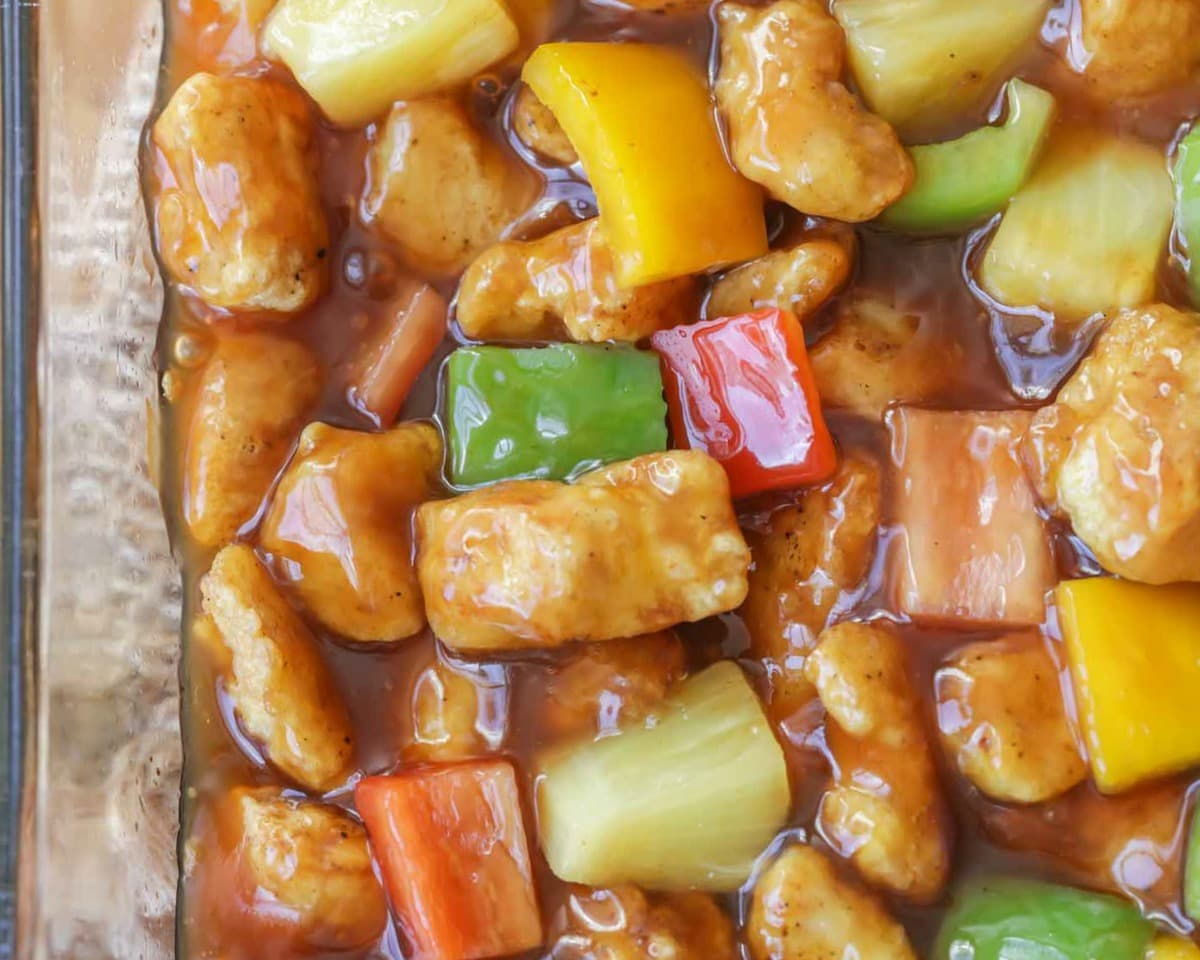 Asian Dinner Recipes - Baked Sweet And Sour Chicken in a white serving dish. 