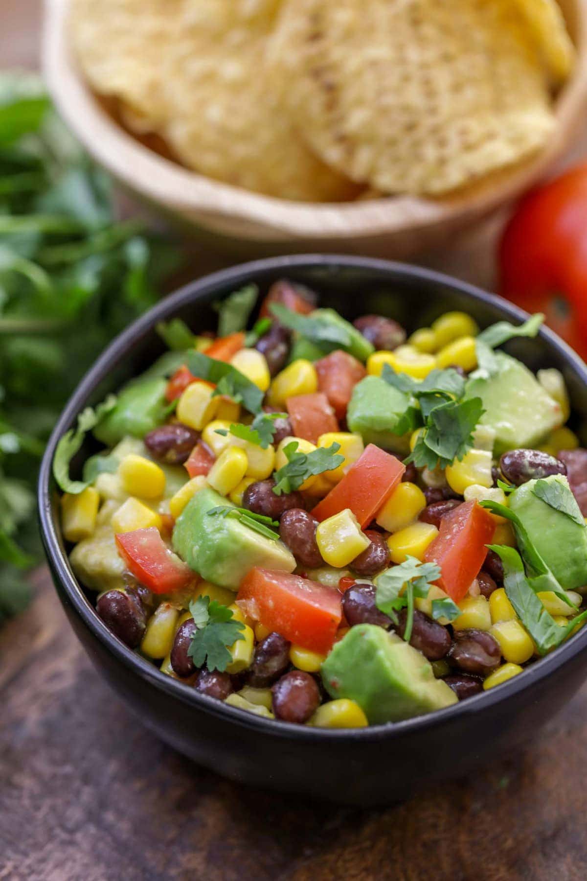 Black Bean Corn Salsa Recipe in a black bowl close up image.