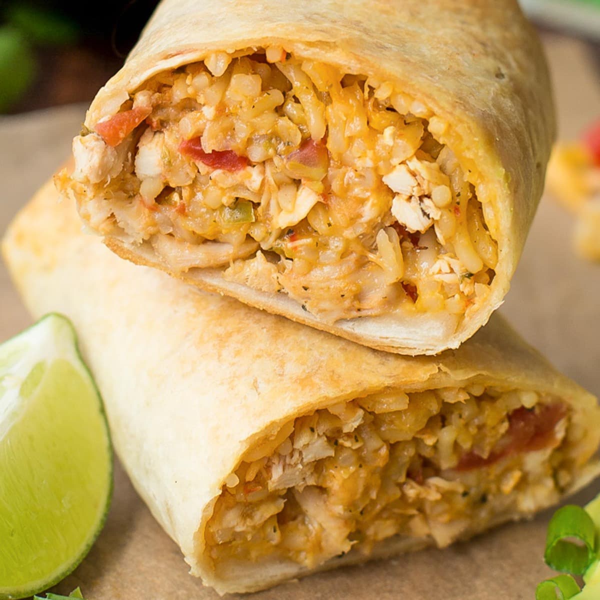 Rice and baked Chicken Chimichanga cut in half and stacked on a plate.