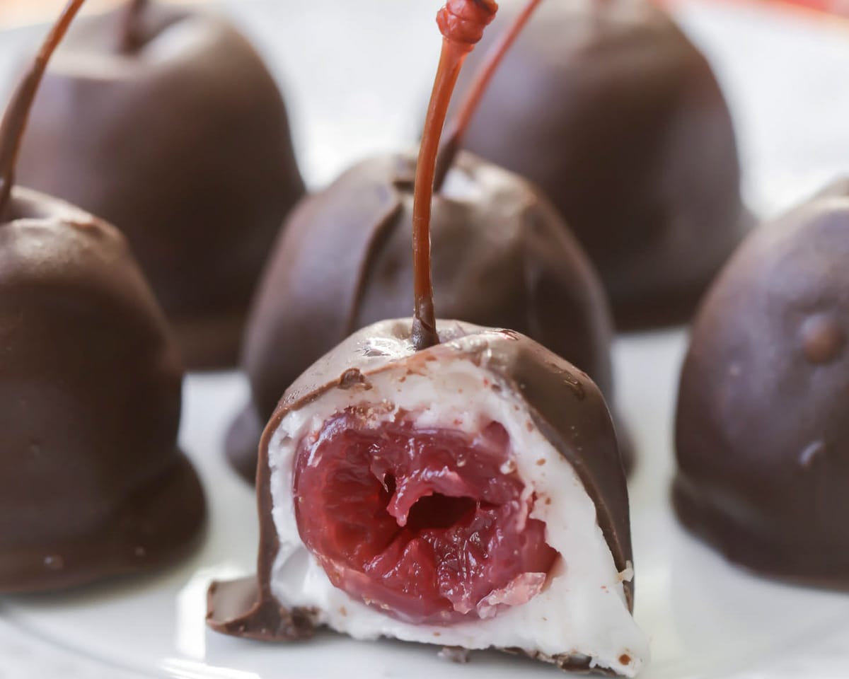 Chocolate Covered Cherries cut in half on a white plate