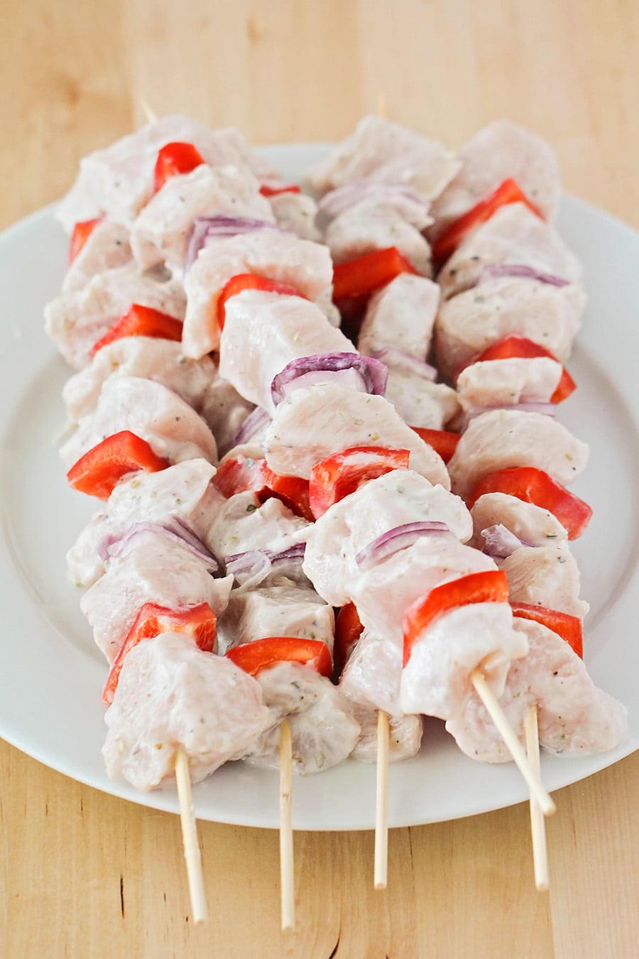 Greek chicken souvlaki skewers marinating before going in the oven