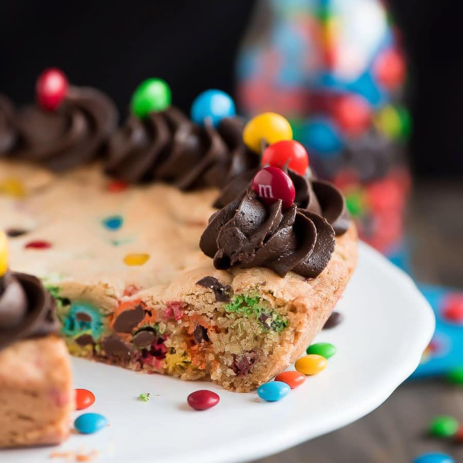 Close up of M&M Cake with chocolate buttercream frosting on top