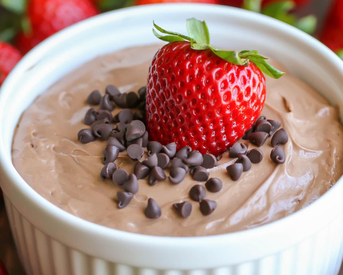 Appetizer Dips - Nutella Dip topped with mini chocolate chips and a whole strawberry in a white ramekin. 