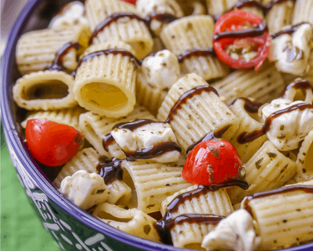 Caprese Pasta Salad drizzled with balsamic vinegar