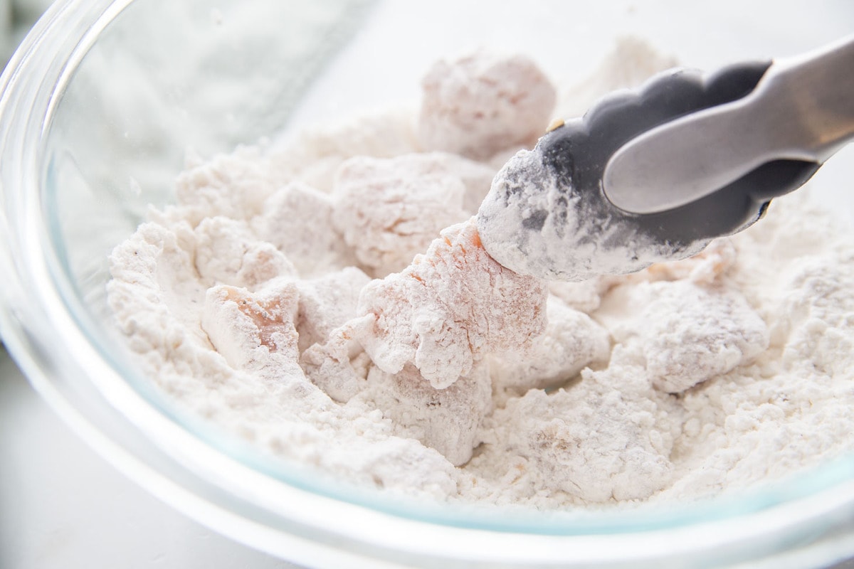 Cubed Chicken in cornstarch in glass bowl