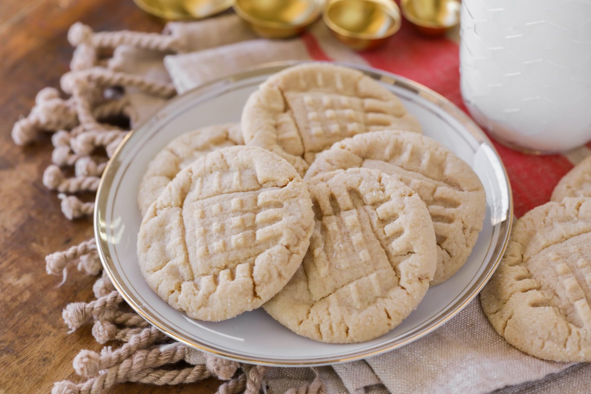 Easy cookie recipes - soft peanut butter cookies piled on a white plate..