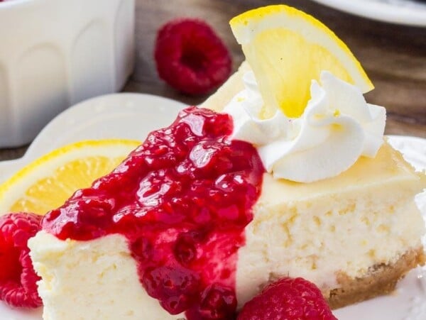 This lemon cheesecake is smooth and creamy with a crunchy graham cracker crust and delicious lemon flavor. Then it's topped with raspberry sauce for the perfect flavor combo. 