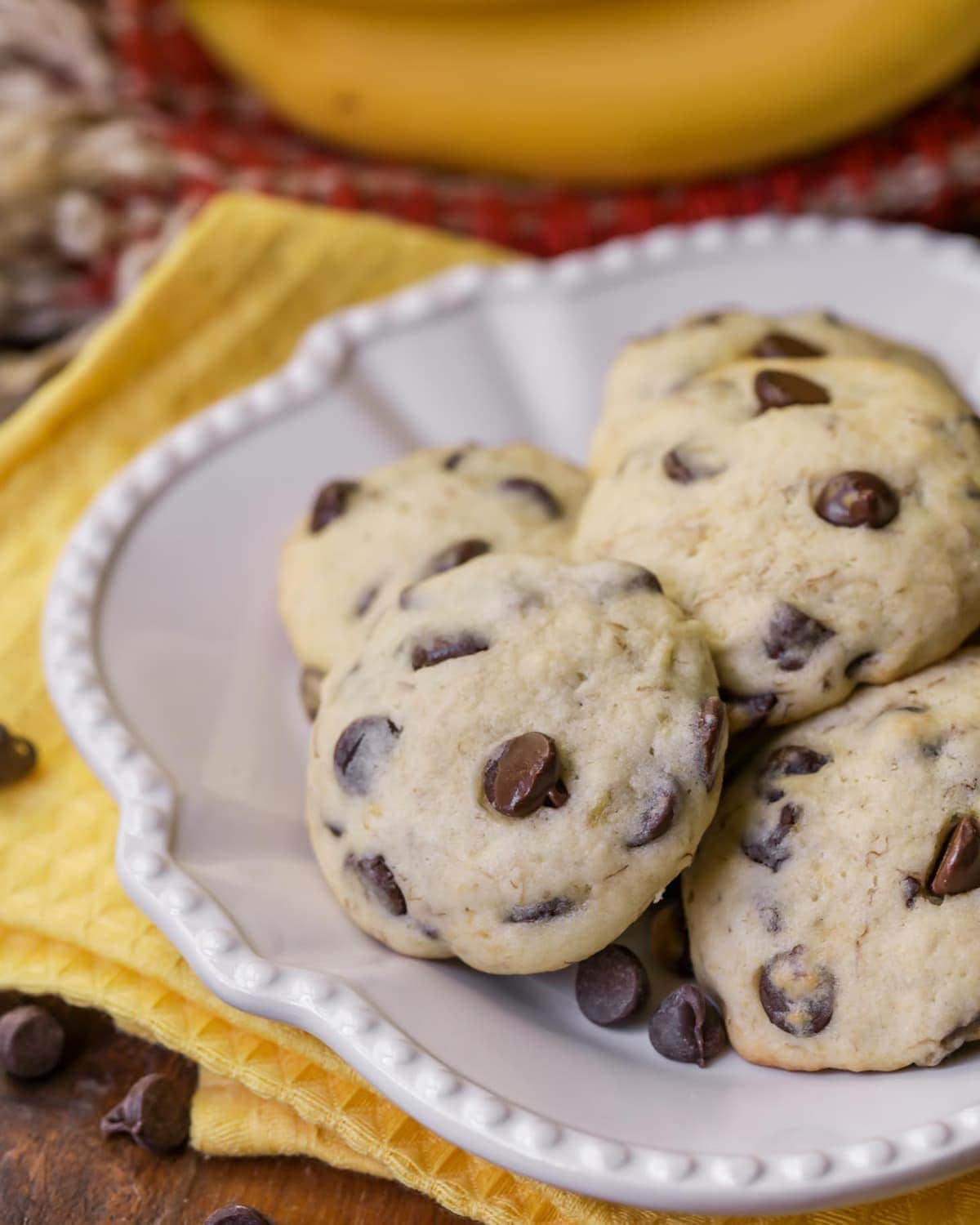 banana chocolate chip cookies stacked on a white plate