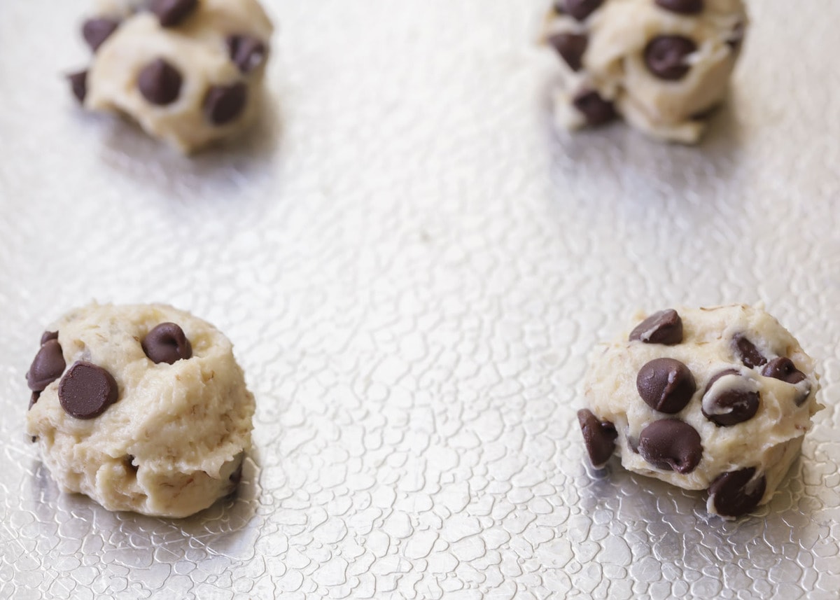 cookie dough scooped onto a cookie sheet