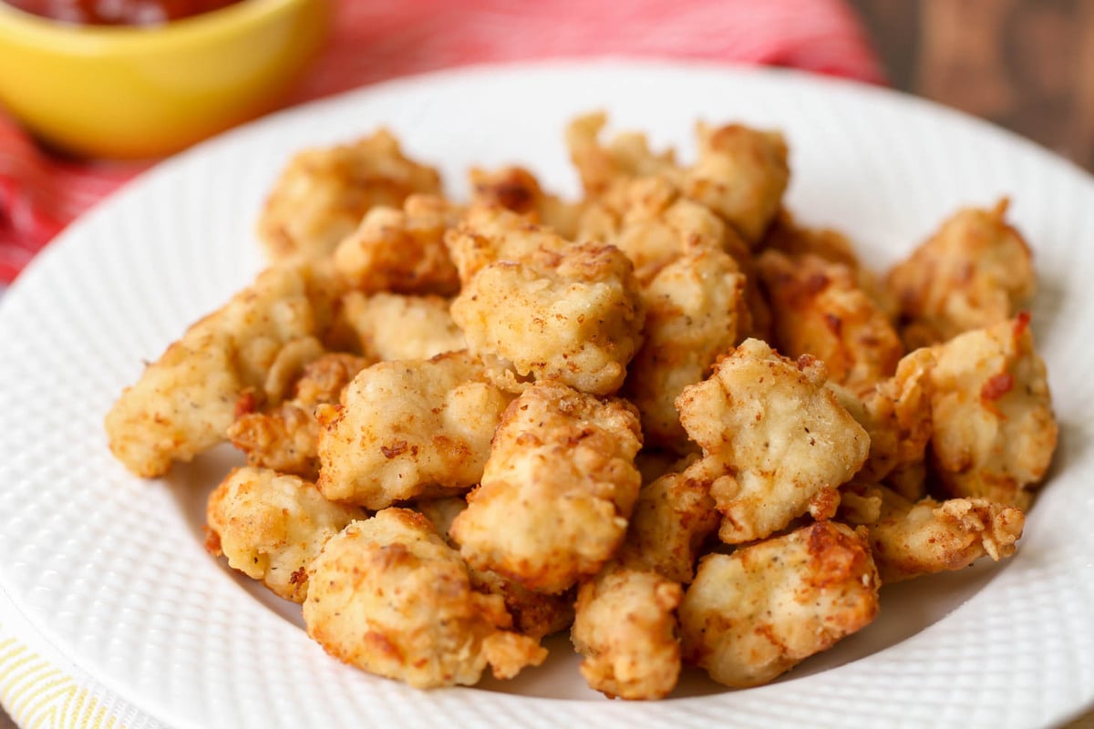 A white plate filled with chick fil a nuggets.