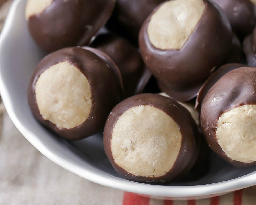 5 Ingredient Recipes - Easy buckeyes piled in a white bowl.
