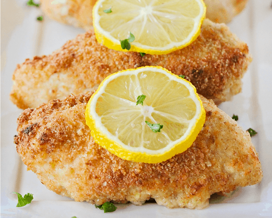 Baked Parmesan Crusted Chicken with a slice of lemon on top.