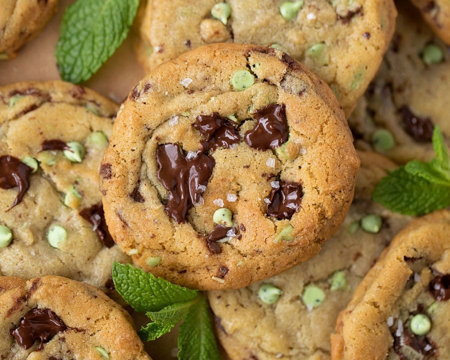 mint chocolate chip cookies stacked on a cutting board