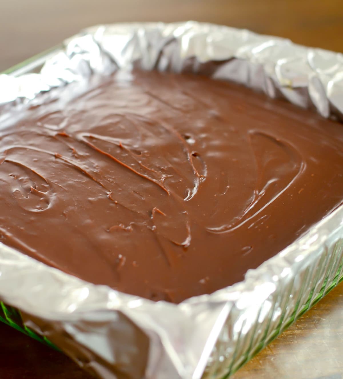 Nutella topped chocolate brownies in a baking dish lined with foil