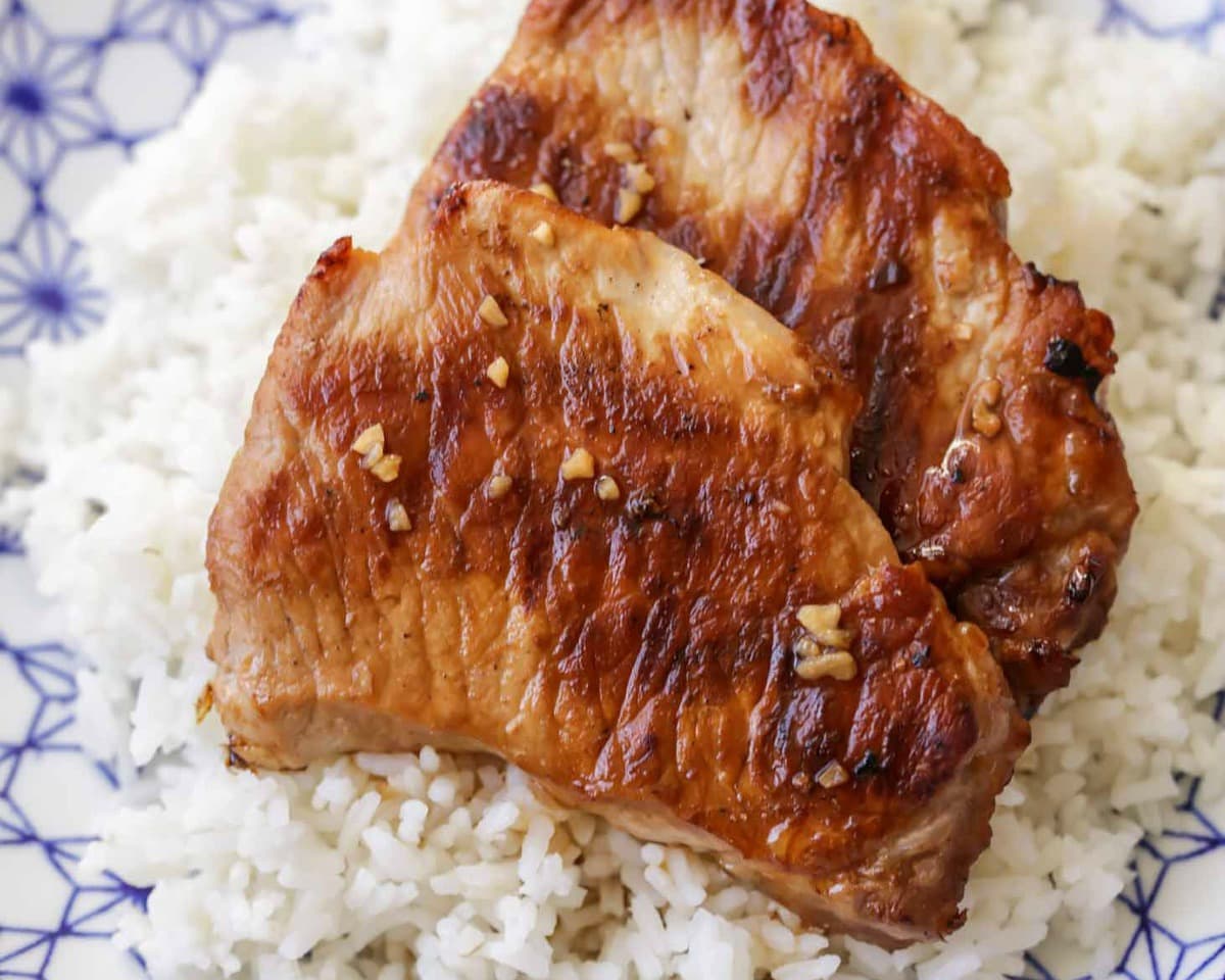 Teriyaki Pork Chops served on a bed of rice.