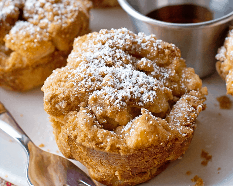 French Toast muffins close up image with powdered sugar on top.