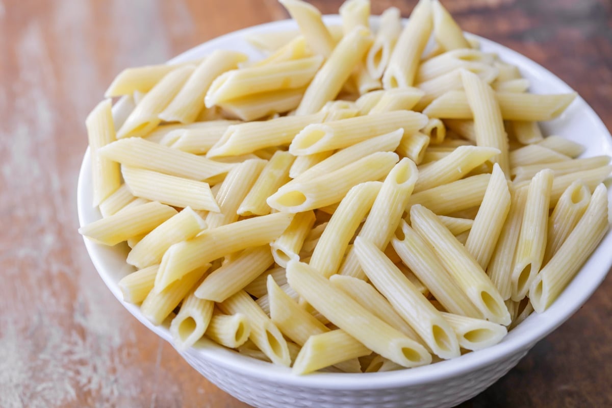 white bowl filled with penne pasta