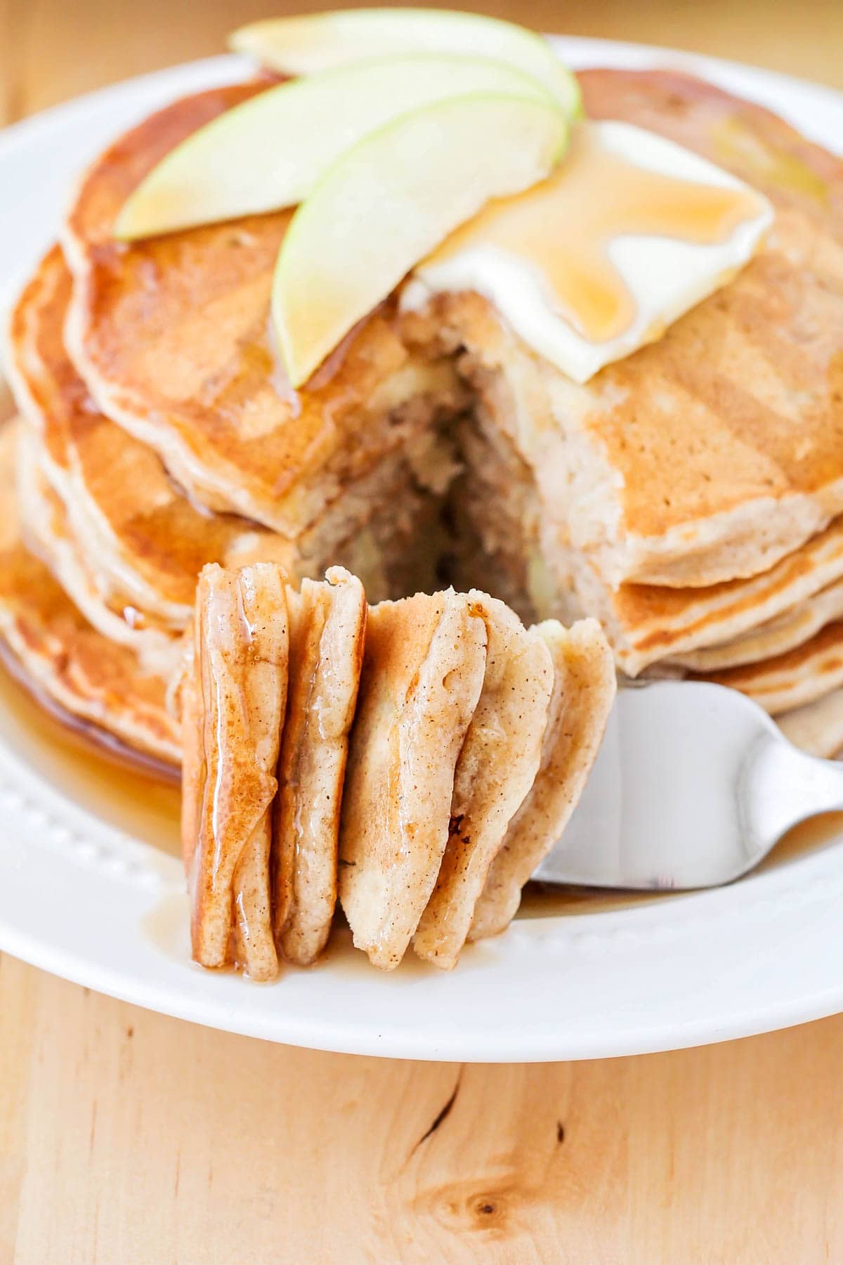 Apple pancakes topped with butter and syrup