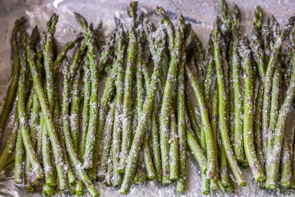 Baked parmesan asparagus sprinkled with parmesan cheese.