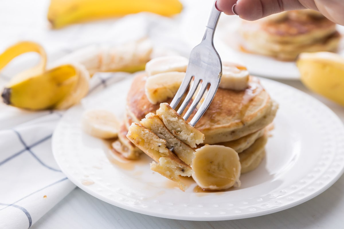 Banana Pancakes stacked on white plate