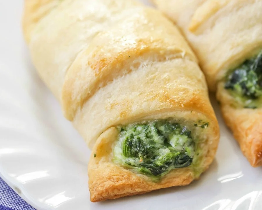 Cheesy Spinach Rolls on a white plate