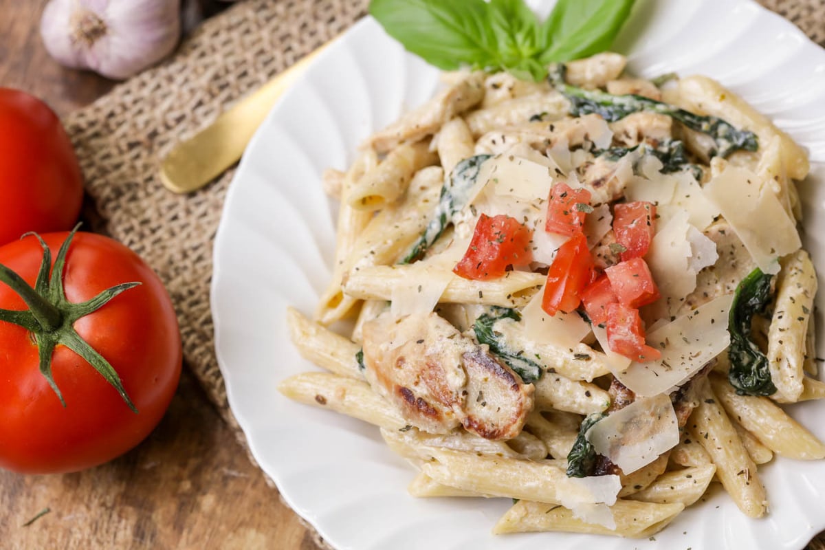 Pesto chicken florentine on a white plate.