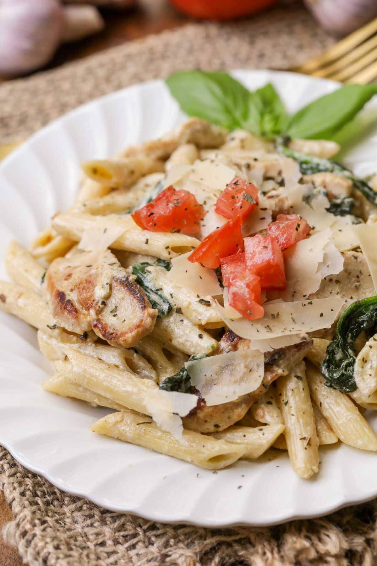 Chicken Florentine garnished with fresh diced tomatoes