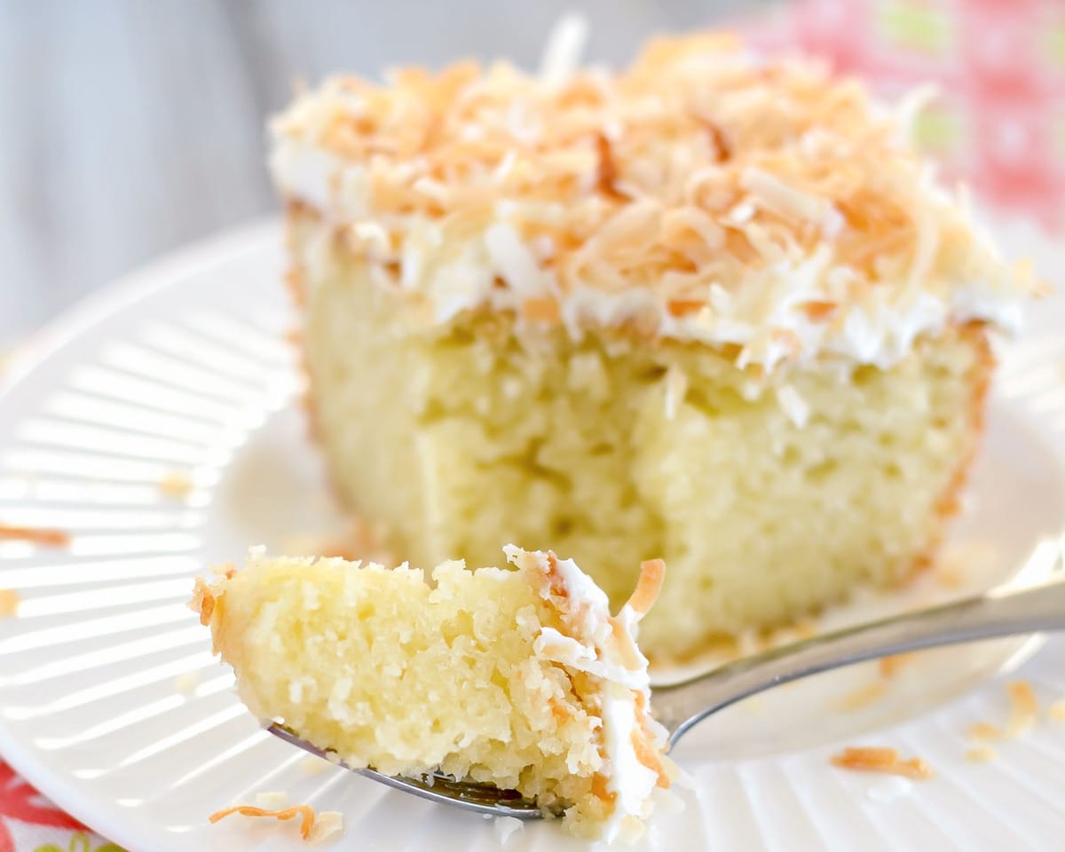 Coconut cake recipe with a bite on a fork.