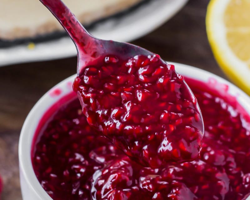Raspberry sauce for cheesecake on a spoon