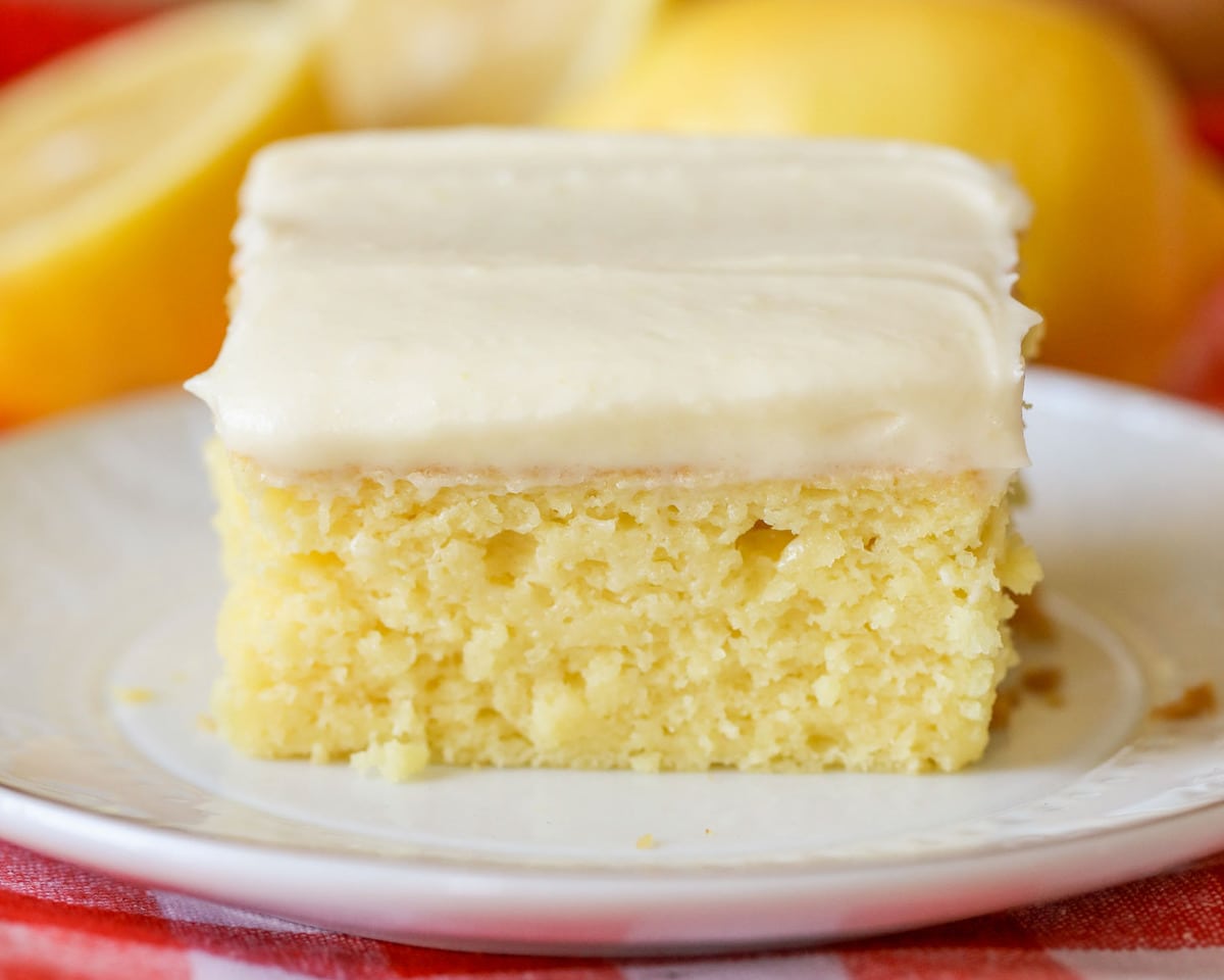 Easy Cake Recipes - A slice of lemon sheet cake on a white plate.