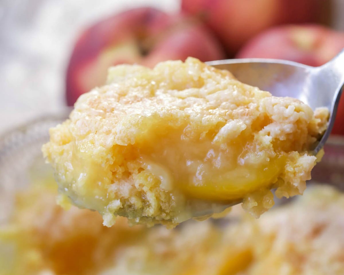 Summer Recipes - Closeup of peach dump cake on a spoon.