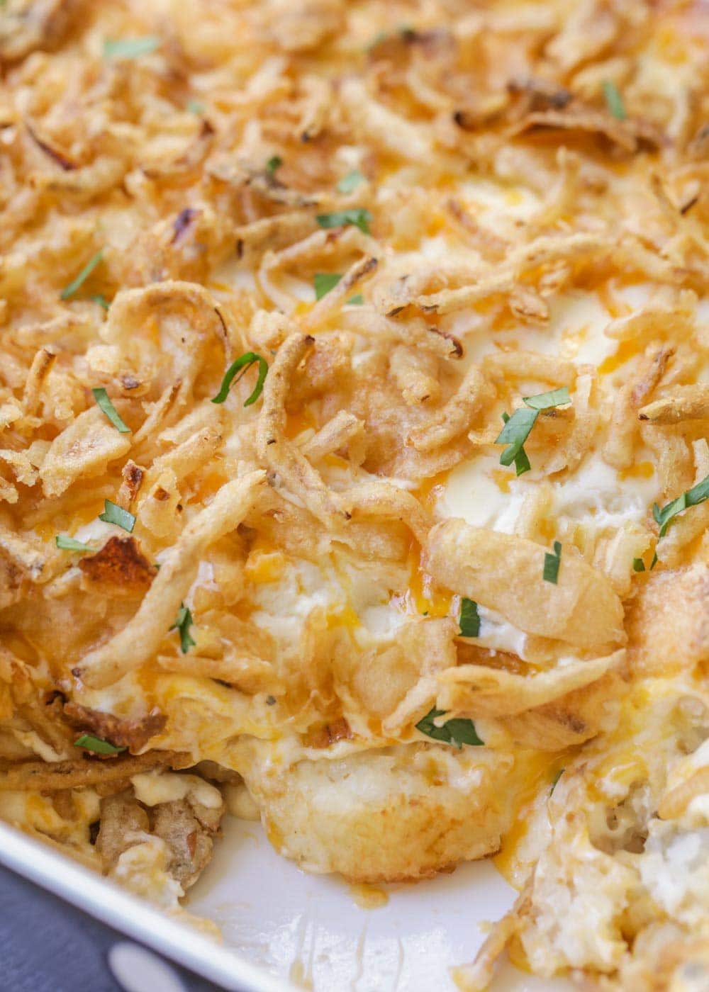 Easy tater tot casserole recipe topped with fresh herbs.