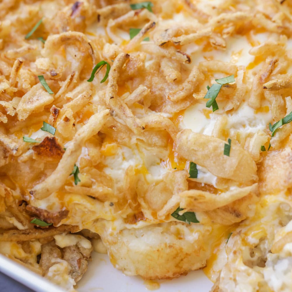 Tater tot casserole recipe close up topped with onions.