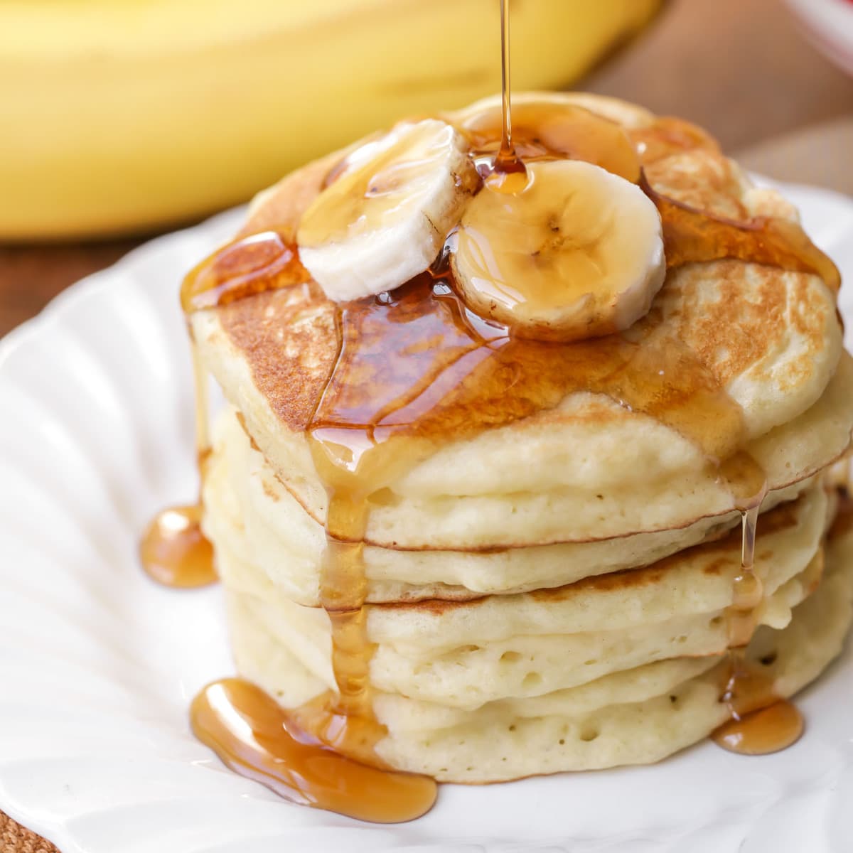 Yogurt Pancakes being topped with maple syrup