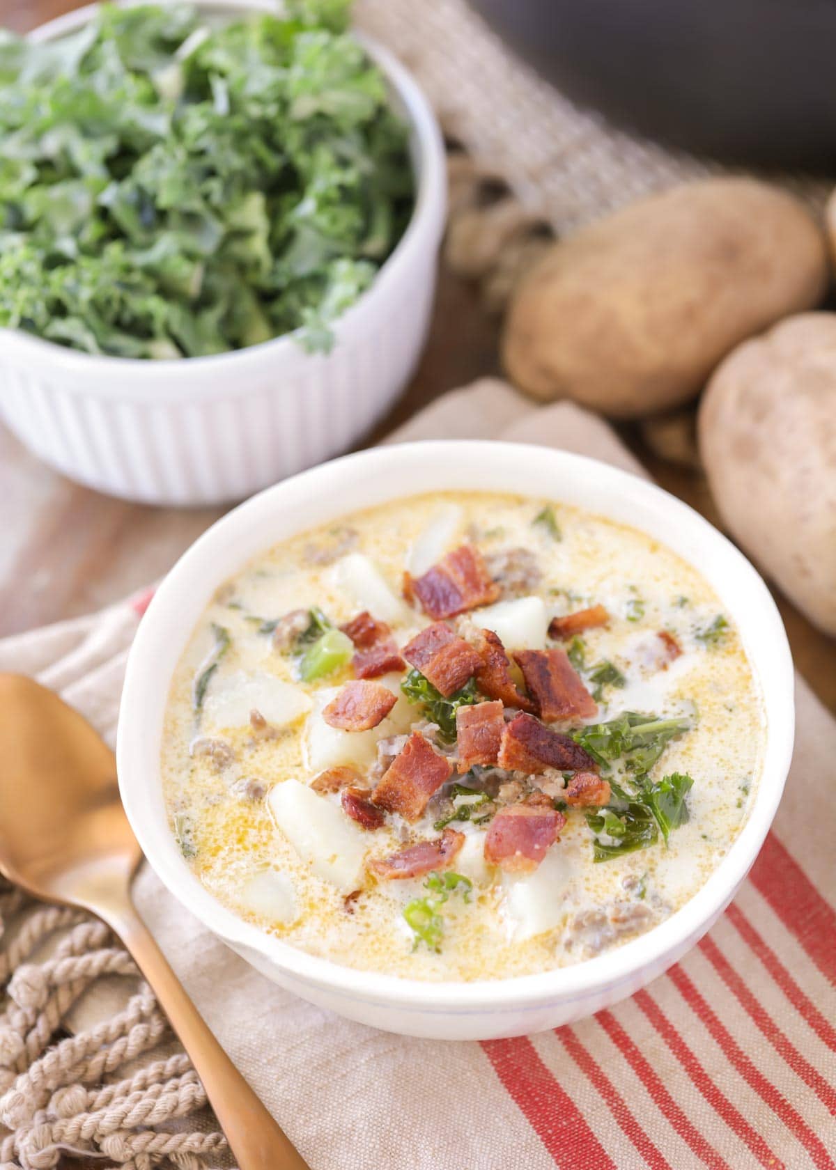Olive Garden Zuppa Toscana soup topped with crumbled bacon