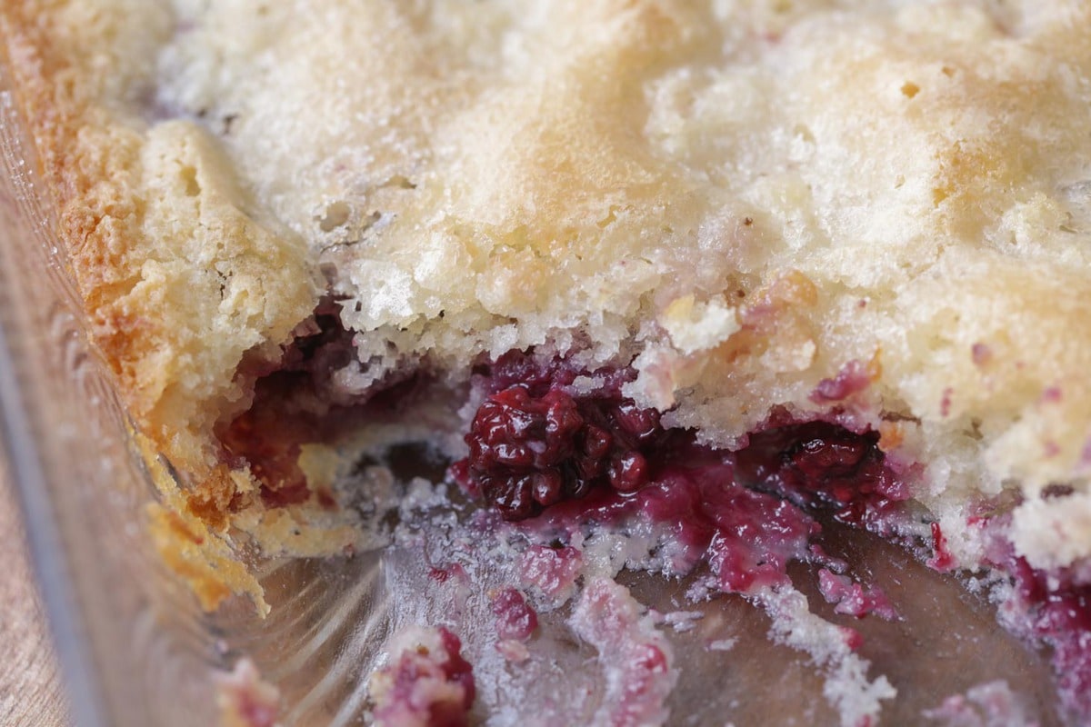 Closeup of blackberry cobbler recipe with a scoop taken out