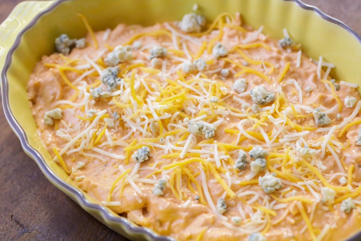 Buffalo dip topped with shredded cheese and blue cheese.