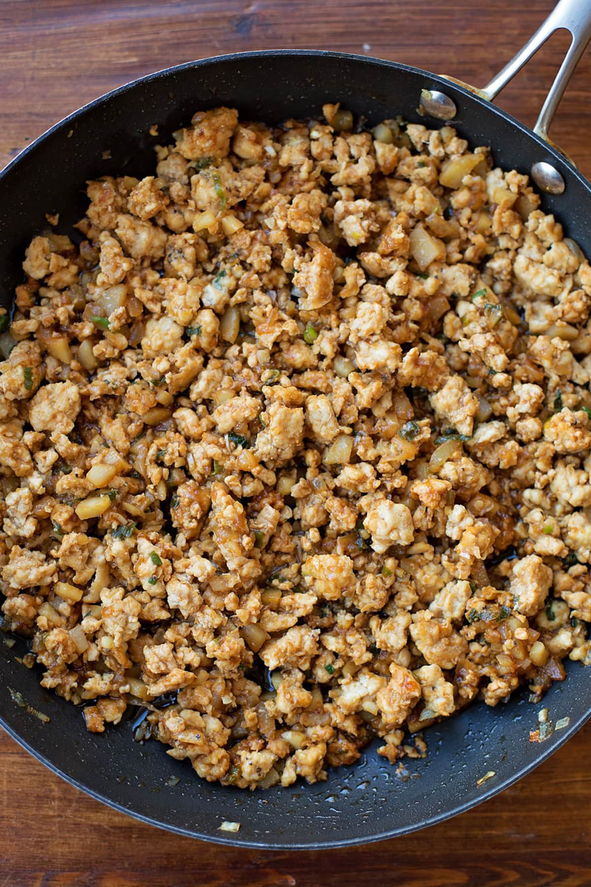Ground chicken mixture for lettuce wraps in a skillet