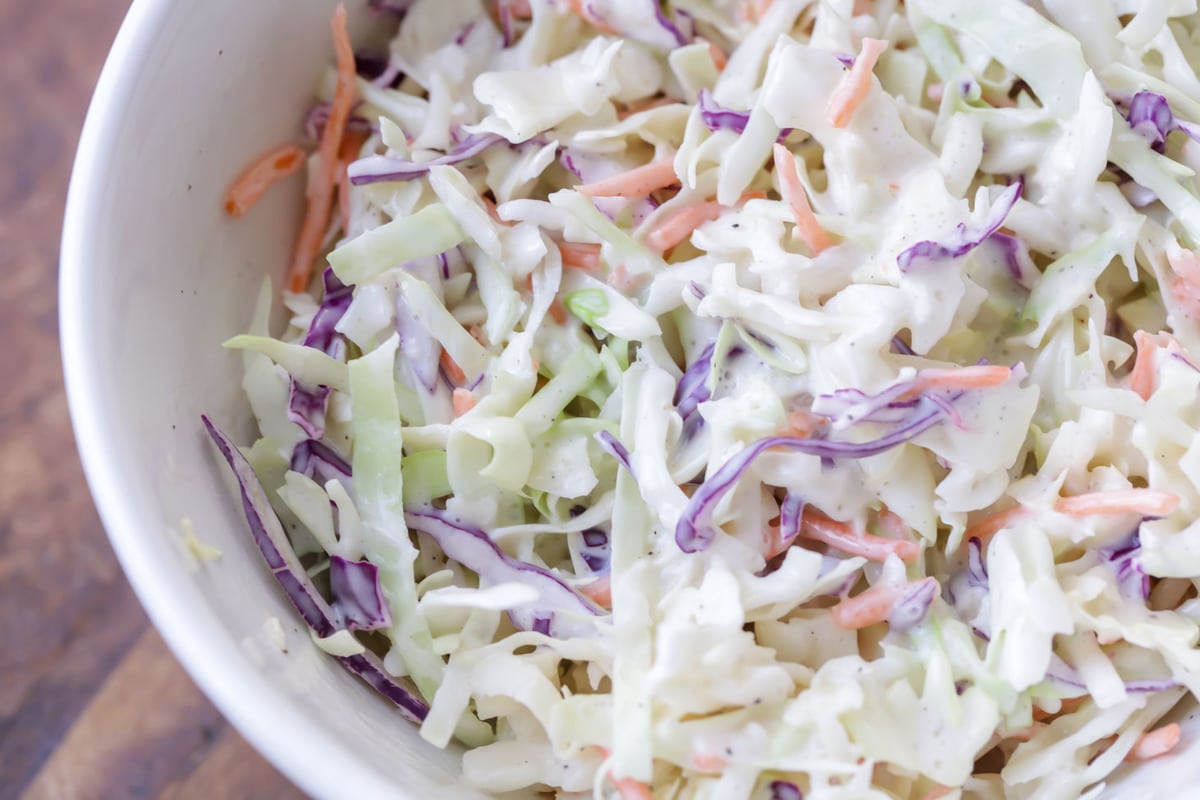 A white bowl filled with easy coleslaw.