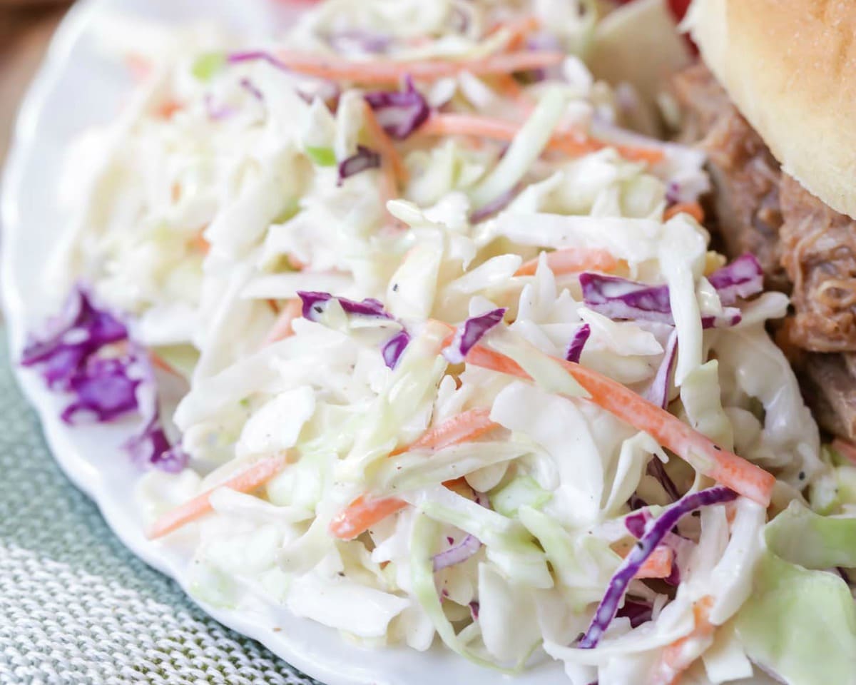 Best Coleslaw Recipe on plate with pulled pork sandwich