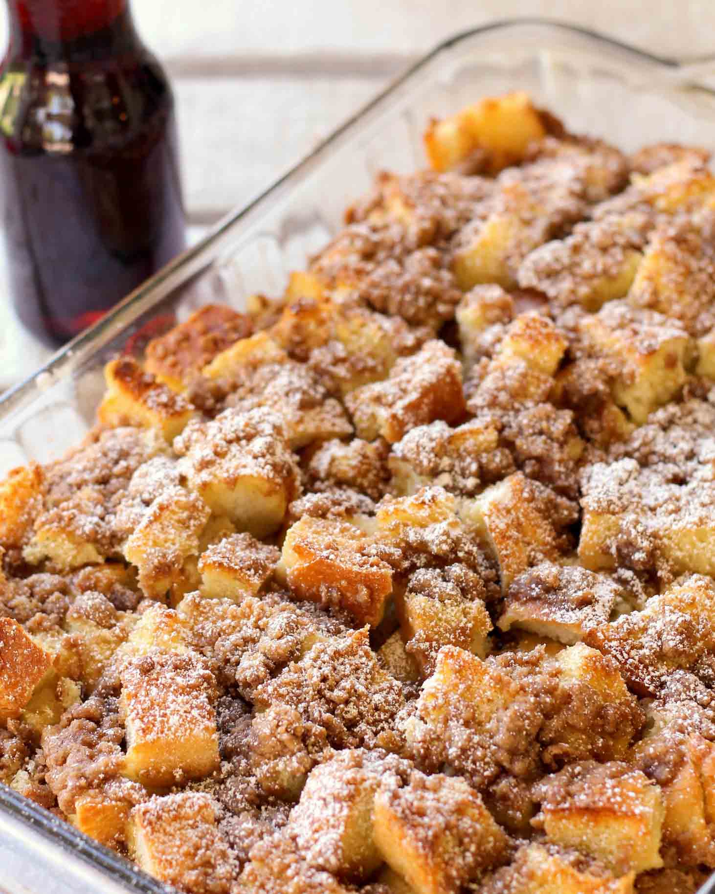 French Toast Casserole served in a baking dish topped with powdered sugar.