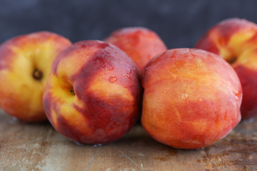 Fresh peaches on a cutting board to use in peach cobbler.