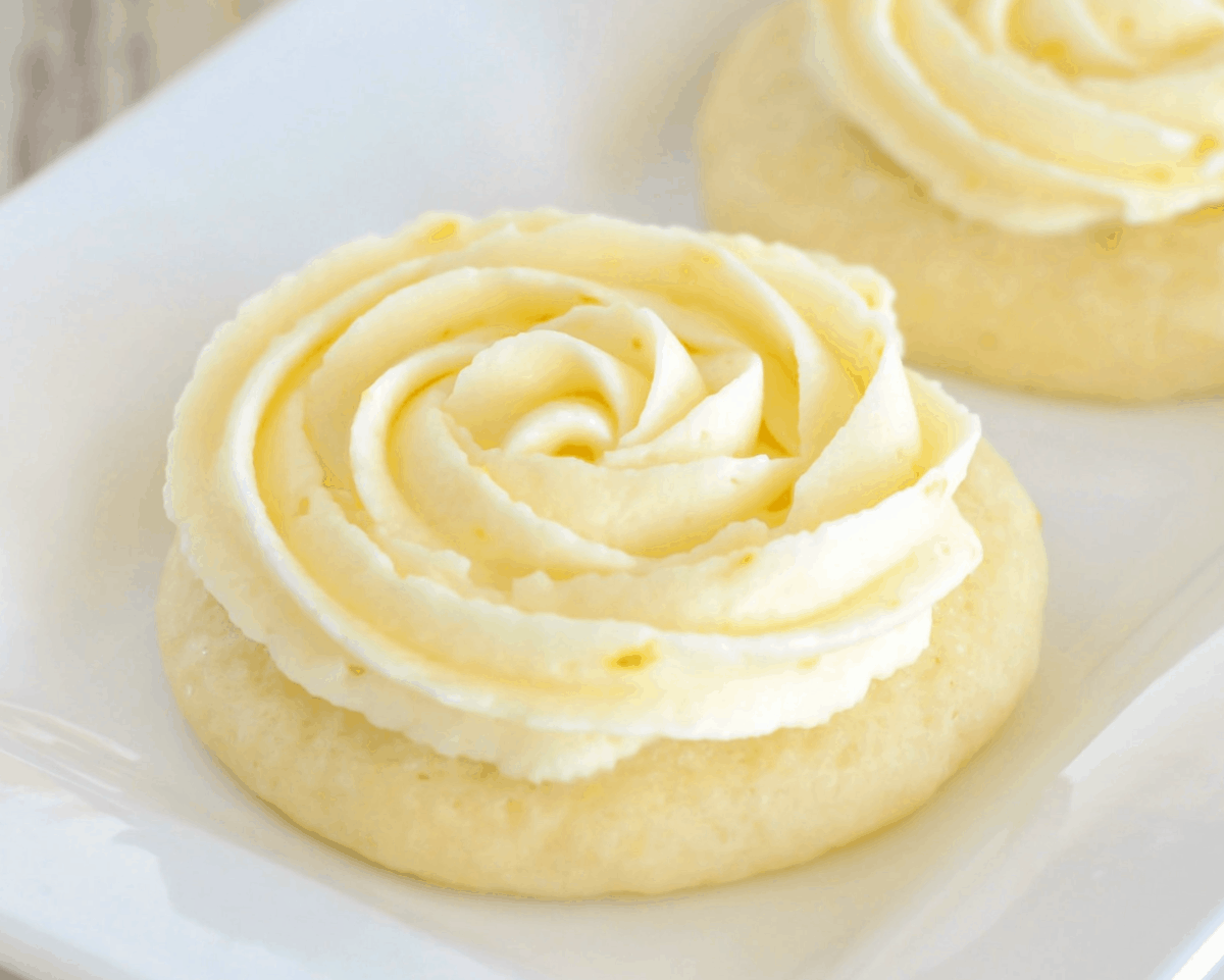 Sugar cookie recipes - lemon sugar cookies topped with a yellow frosting rosette.