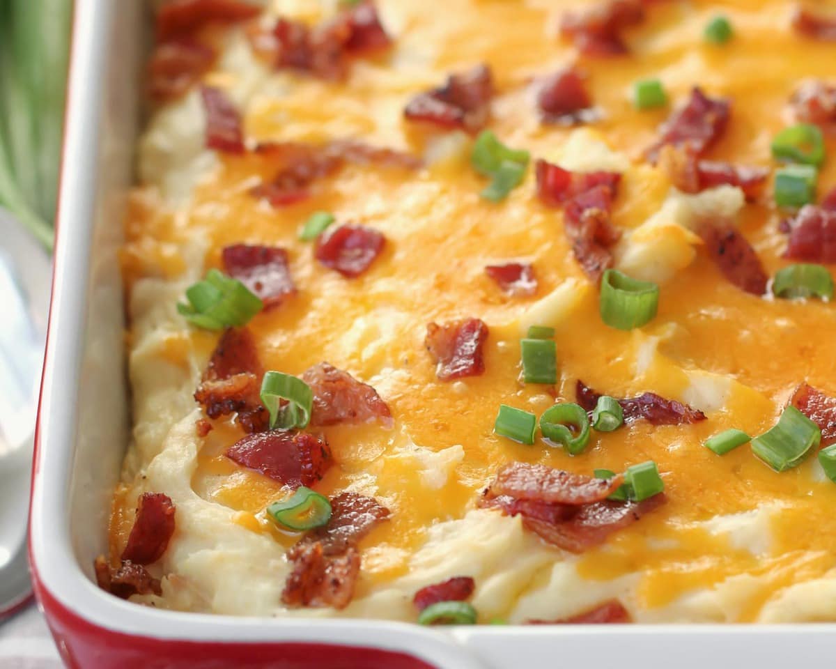 Easy side dishes - cheesy mashed potato casserole topped with bacon and green onion.