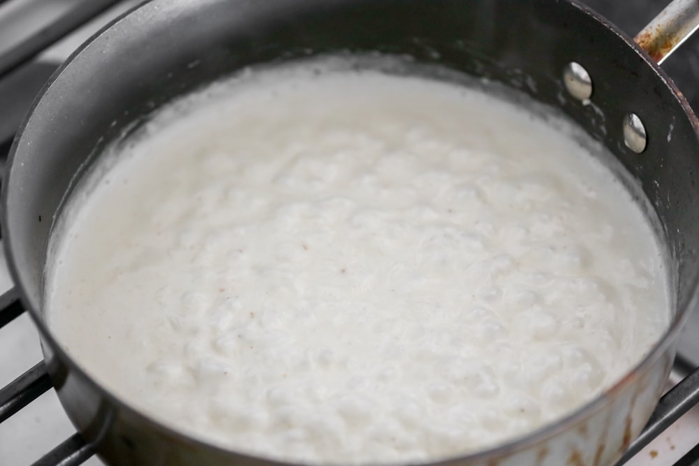 Nacho cheese sauce cooking in a saucepan